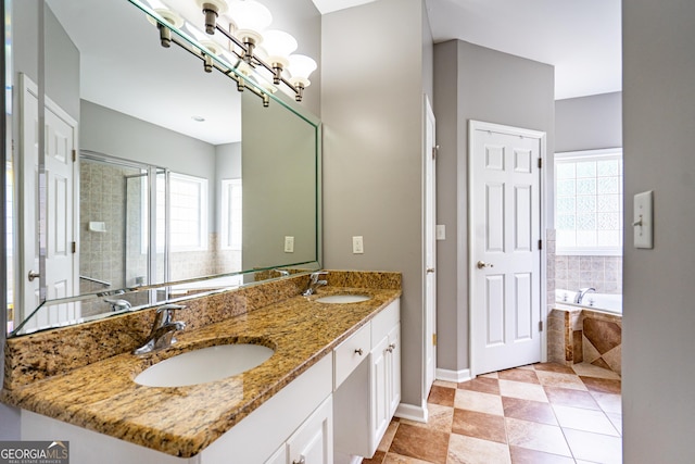 bathroom featuring baseboards, a sink, a bath, and double vanity