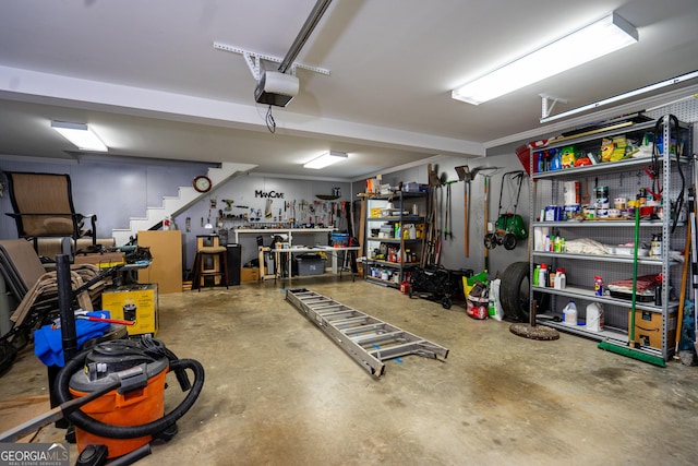 garage with a workshop area and a garage door opener