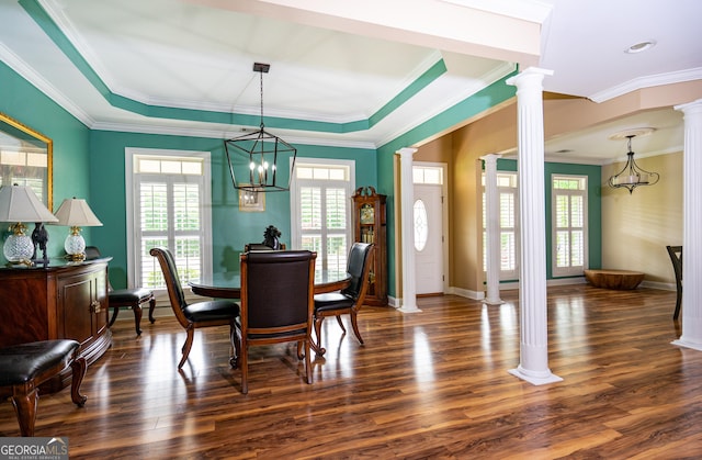 dining area with ornate columns, ornamental molding, baseboards, and dark wood-style floors
