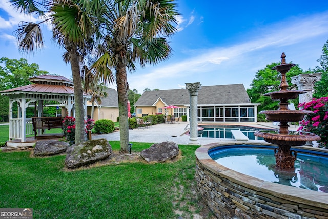 outdoor pool featuring a sunroom, a patio, a gazebo, and a yard