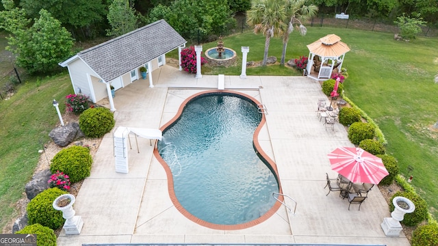 pool with a lawn, a patio, a gazebo, and an exterior structure