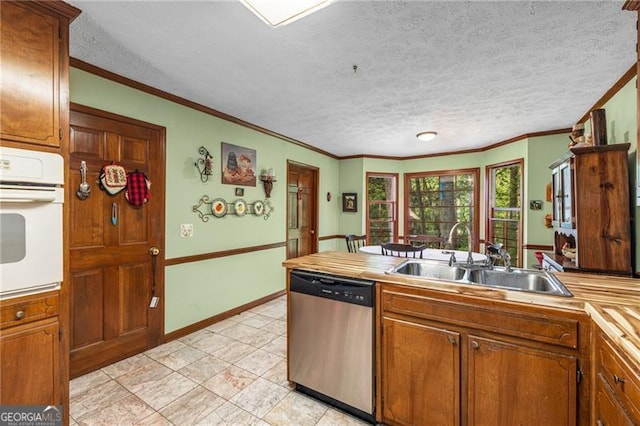 kitchen with brown cabinetry, a textured ceiling, white oven, dishwasher, and a sink