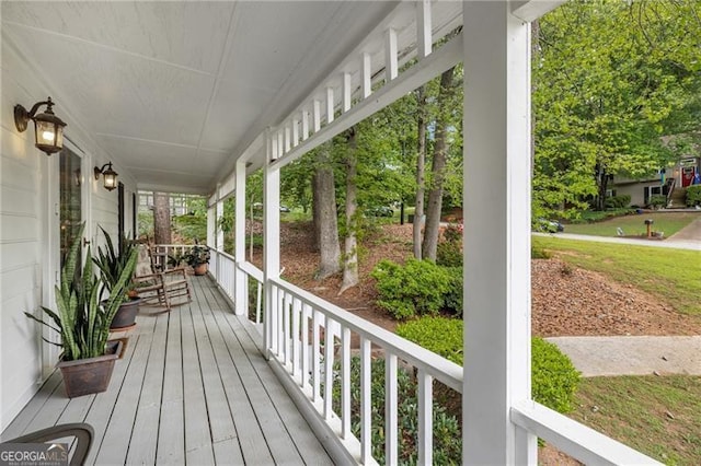 wooden terrace featuring covered porch