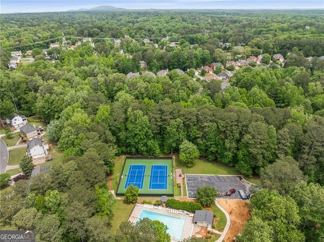 birds eye view of property featuring a view of trees