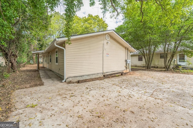 view of side of home featuring driveway