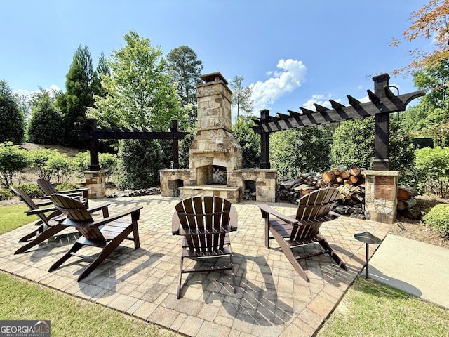 view of patio featuring an outdoor stone fireplace and a pergola