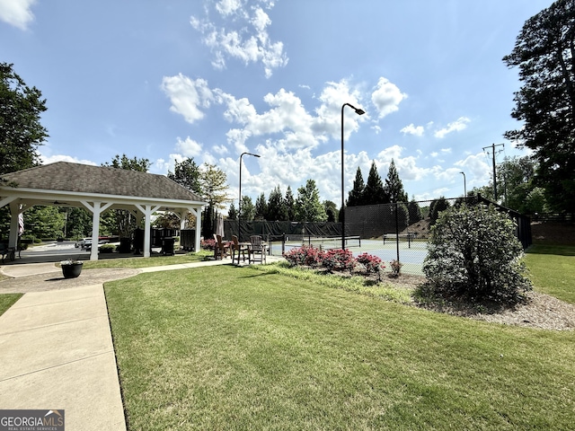 surrounding community with a yard, fence, a gazebo, and a tennis court