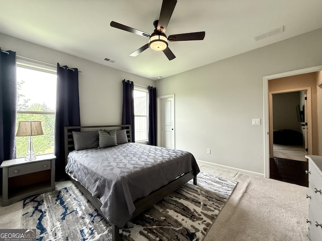 bedroom with multiple windows, a ceiling fan, and visible vents