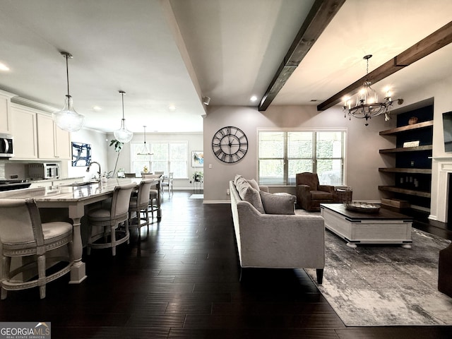 living room featuring recessed lighting, beamed ceiling, a notable chandelier, and dark wood-style floors