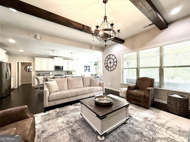 living room featuring an inviting chandelier, baseboards, and beamed ceiling