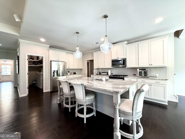 kitchen with crown molding, recessed lighting, white cabinetry, and appliances with stainless steel finishes
