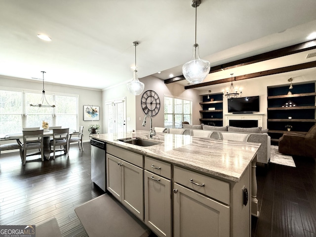 kitchen with dishwasher, a sink, light stone counters, an inviting chandelier, and dark wood-type flooring