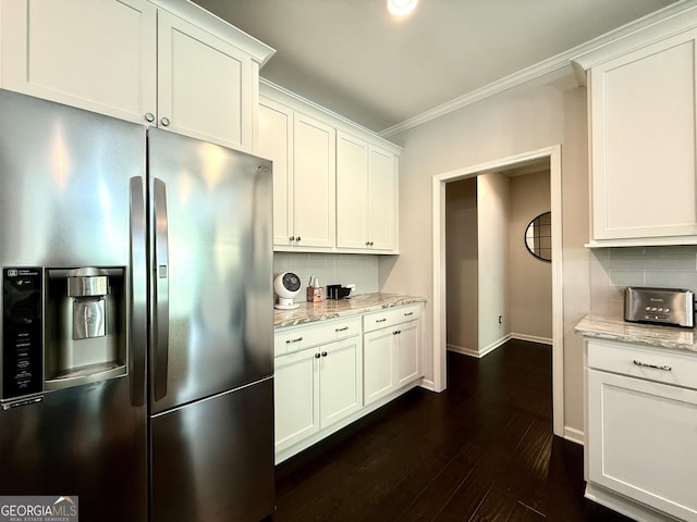 kitchen featuring ornamental molding, decorative backsplash, white cabinetry, and stainless steel fridge with ice dispenser