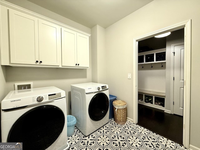 laundry room featuring cabinet space, independent washer and dryer, baseboards, and tile patterned floors