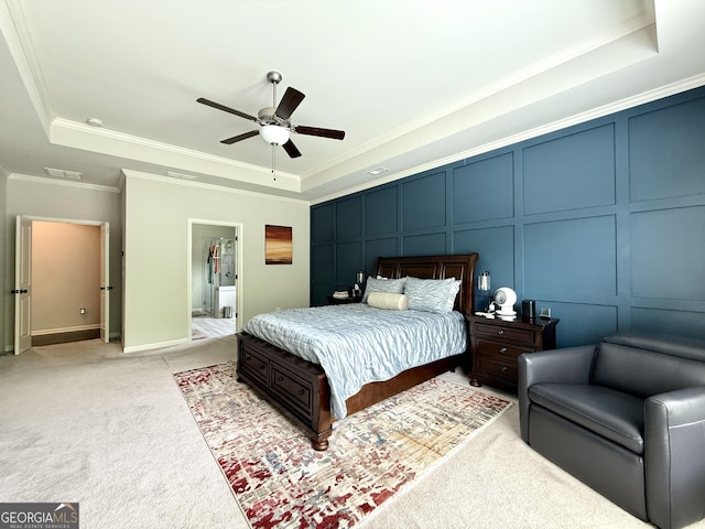 bedroom with a raised ceiling, ornamental molding, a decorative wall, and visible vents