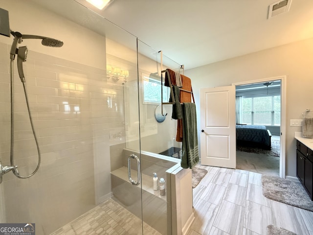 bathroom with vanity, visible vents, a stall shower, and connected bathroom