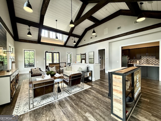 living room with visible vents, dark wood-style flooring, beam ceiling, and high vaulted ceiling