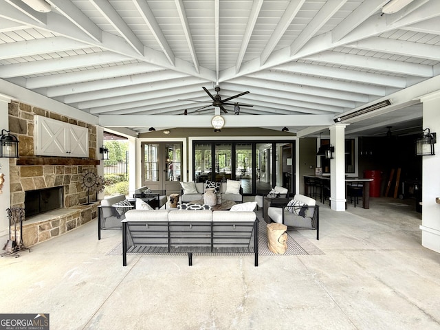 view of patio featuring french doors and an outdoor living space with a fireplace