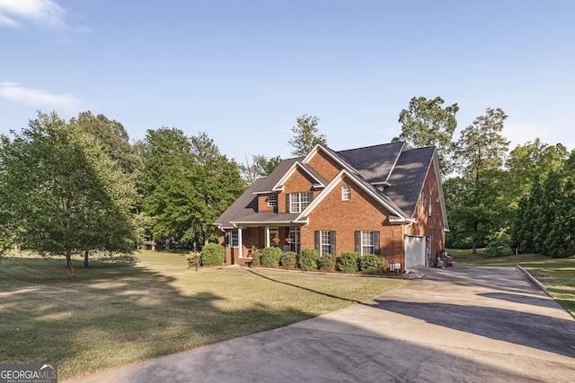 craftsman-style home featuring a garage, a front lawn, brick siding, a porch, and driveway