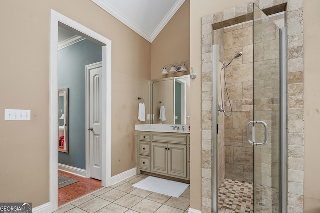 full bathroom featuring vanity, ornamental molding, tile patterned flooring, baseboards, and a shower stall