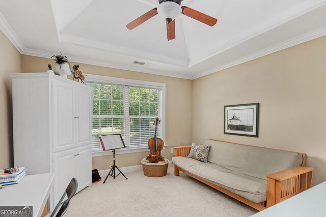 living area with carpet floors, a ceiling fan, a tray ceiling, and visible vents