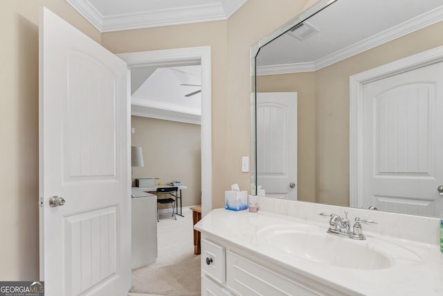 bathroom featuring crown molding, baseboards, visible vents, and vanity
