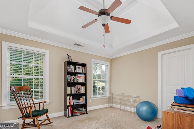 exercise area with carpet flooring, a ceiling fan, baseboards, a tray ceiling, and visible vents