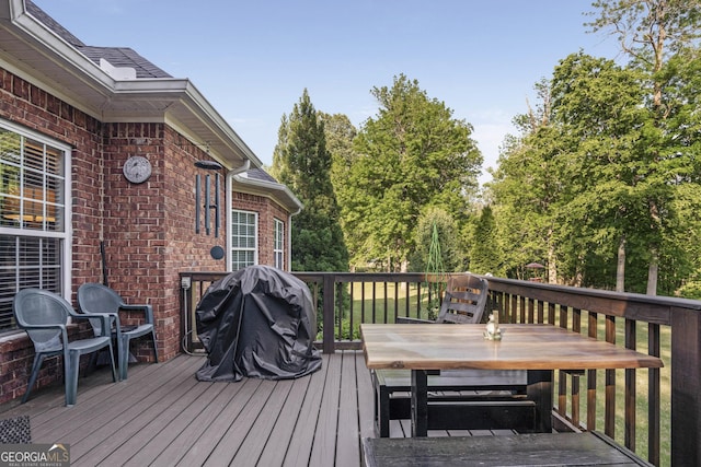 wooden terrace with outdoor dining area
