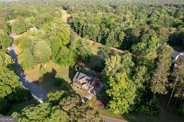drone / aerial view featuring a forest view