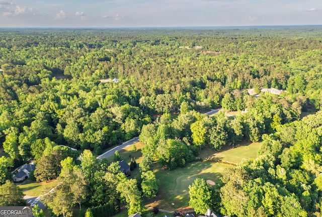 drone / aerial view featuring a wooded view