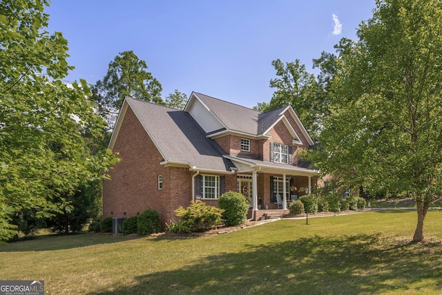 craftsman-style house featuring covered porch, brick siding, and a front yard