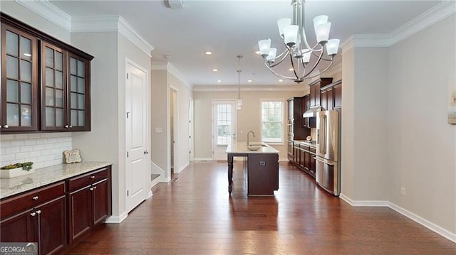 kitchen featuring freestanding refrigerator, a chandelier, recessed lighting, dark wood finished floors, and glass insert cabinets
