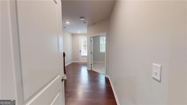 hallway with an upstairs landing, dark wood-style floors, baseboards, and recessed lighting