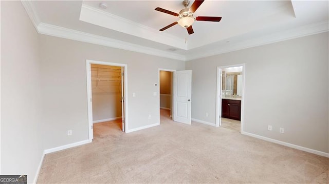 753 Topsail Ln, Alpharetta, GA 30005 - unfurnished bedroom featuring crown molding, a raised ceiling, light colored carpet, a walk in closet, and a closet