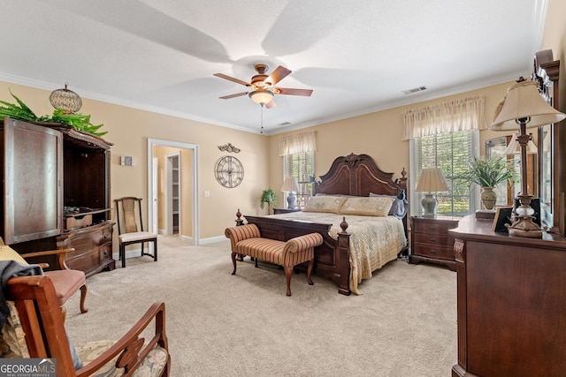 bedroom featuring ceiling fan, visible vents, baseboards, ornamental molding, and light carpet