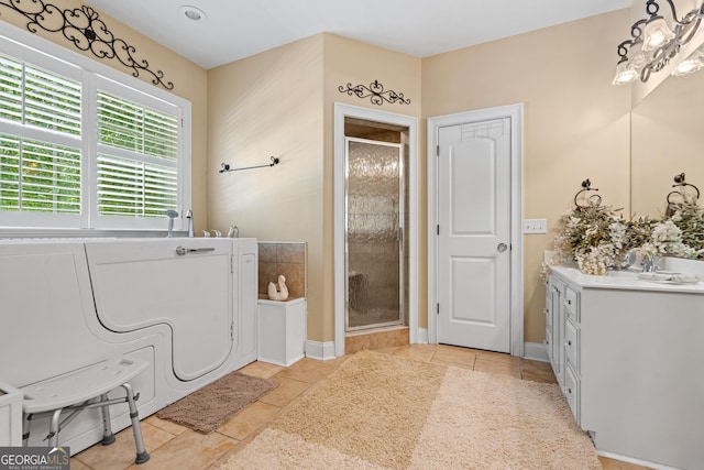 full bath with vanity, tile patterned floors, a bath, and a shower stall