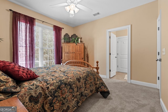 bedroom featuring baseboards, visible vents, ceiling fan, and carpet