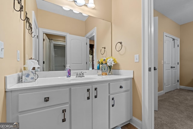 bathroom featuring baseboards and vanity