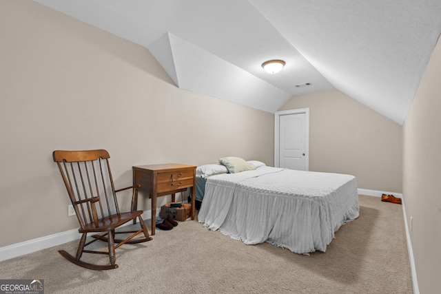 carpeted bedroom with baseboards, visible vents, and lofted ceiling