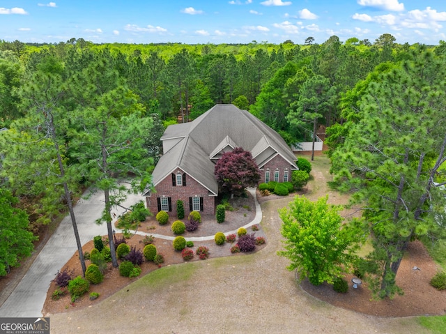 drone / aerial view with a wooded view