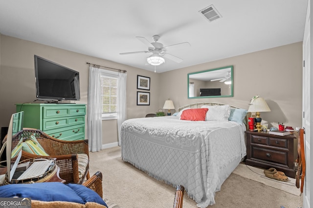 carpeted bedroom featuring a ceiling fan, baseboards, and visible vents