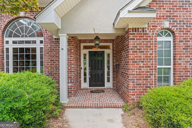 property entrance featuring brick siding