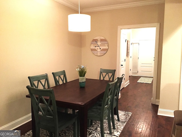 dining space with dark wood-style flooring, baseboards, and ornamental molding