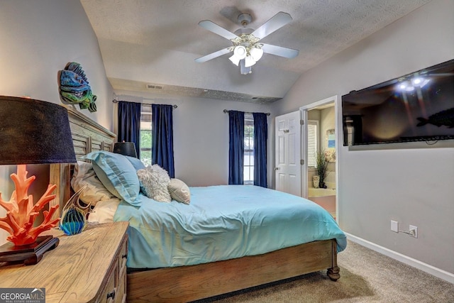 bedroom featuring a ceiling fan, a textured ceiling, vaulted ceiling, carpet floors, and baseboards