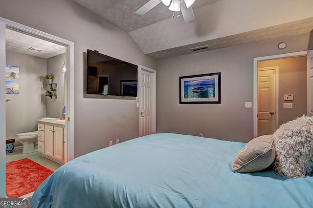 carpeted bedroom featuring visible vents, connected bathroom, a textured ceiling, and lofted ceiling
