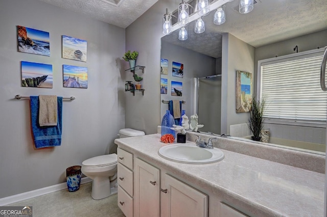 full bath with vanity, a shower, toilet, baseboards, and a textured ceiling