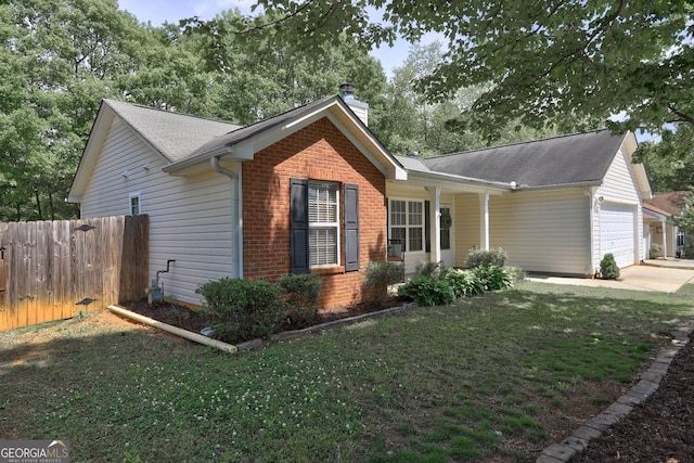 exterior space with a chimney, brick siding, fence, concrete driveway, and an attached garage