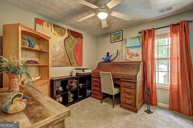 office space with a wealth of natural light, light carpet, ceiling fan, and visible vents