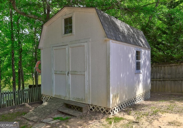 view of shed with fence
