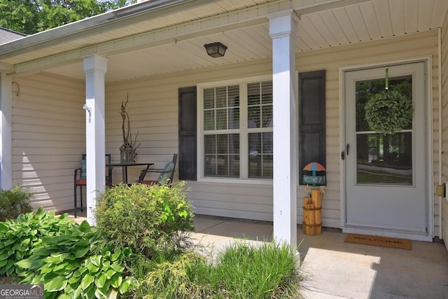 view of exterior entry with a porch